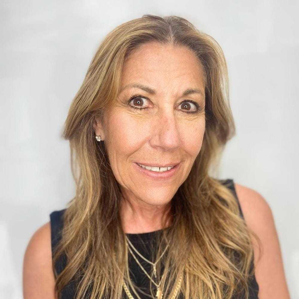 Portrait of Sherry Johnson, a professional stylist at The Greenroom Salon, showcasing their expertise and style.