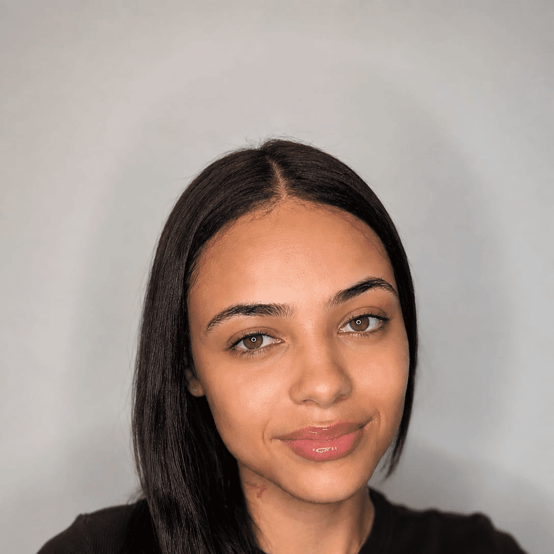 Portrait of Jasmine, a professional stylist at The Greenroom Salon, showcasing their expertise and style.