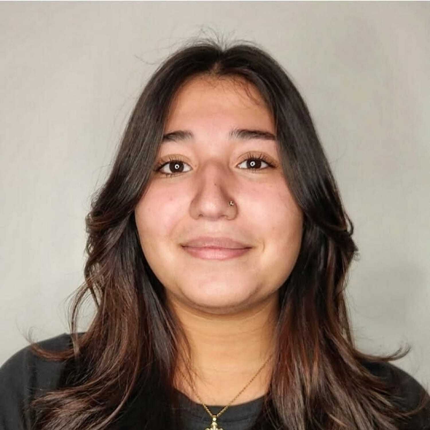 Portrait of Keila, a professional stylist at The Greenroom Salon, showcasing their expertise and style.