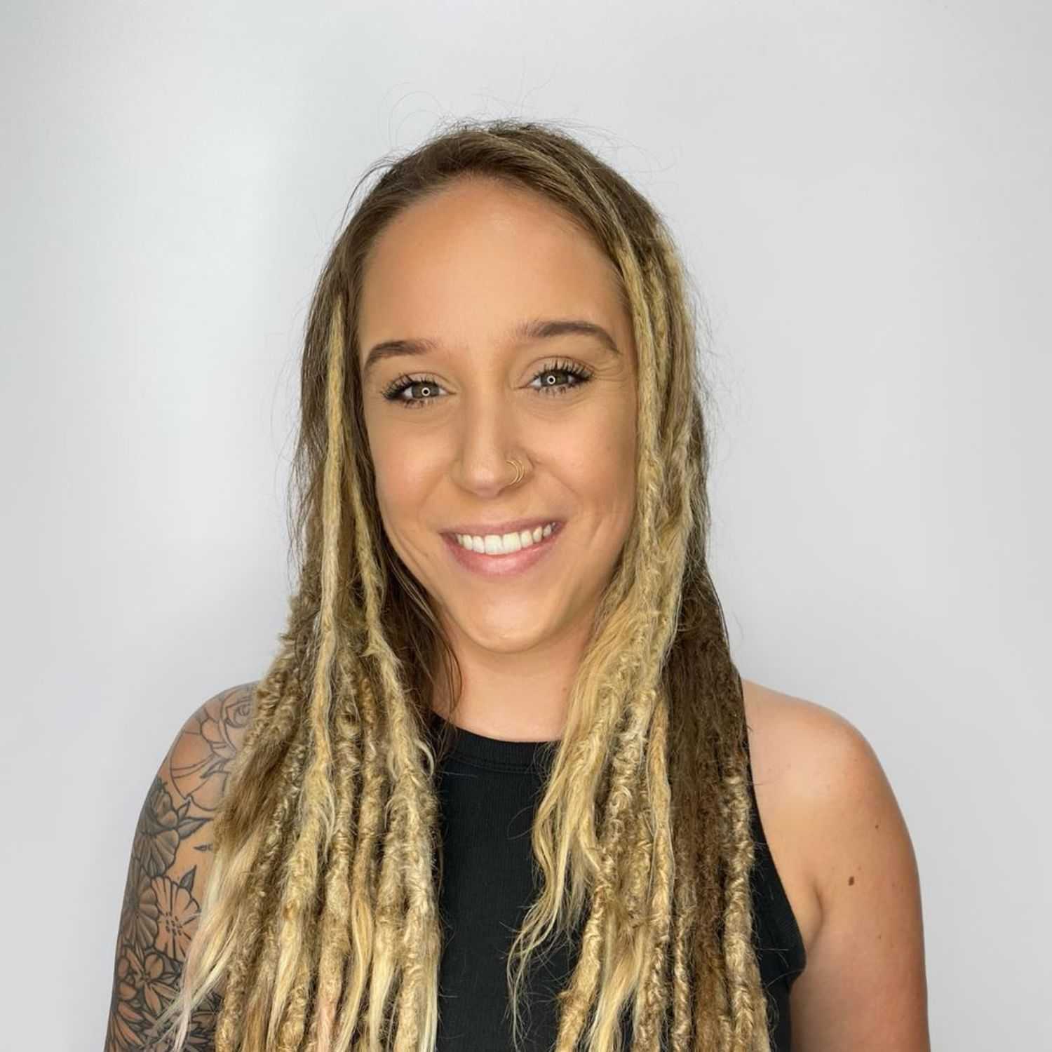 Portrait of Lindsay Newsome, a professional stylist at The Greenroom Salon, showcasing their expertise and style.