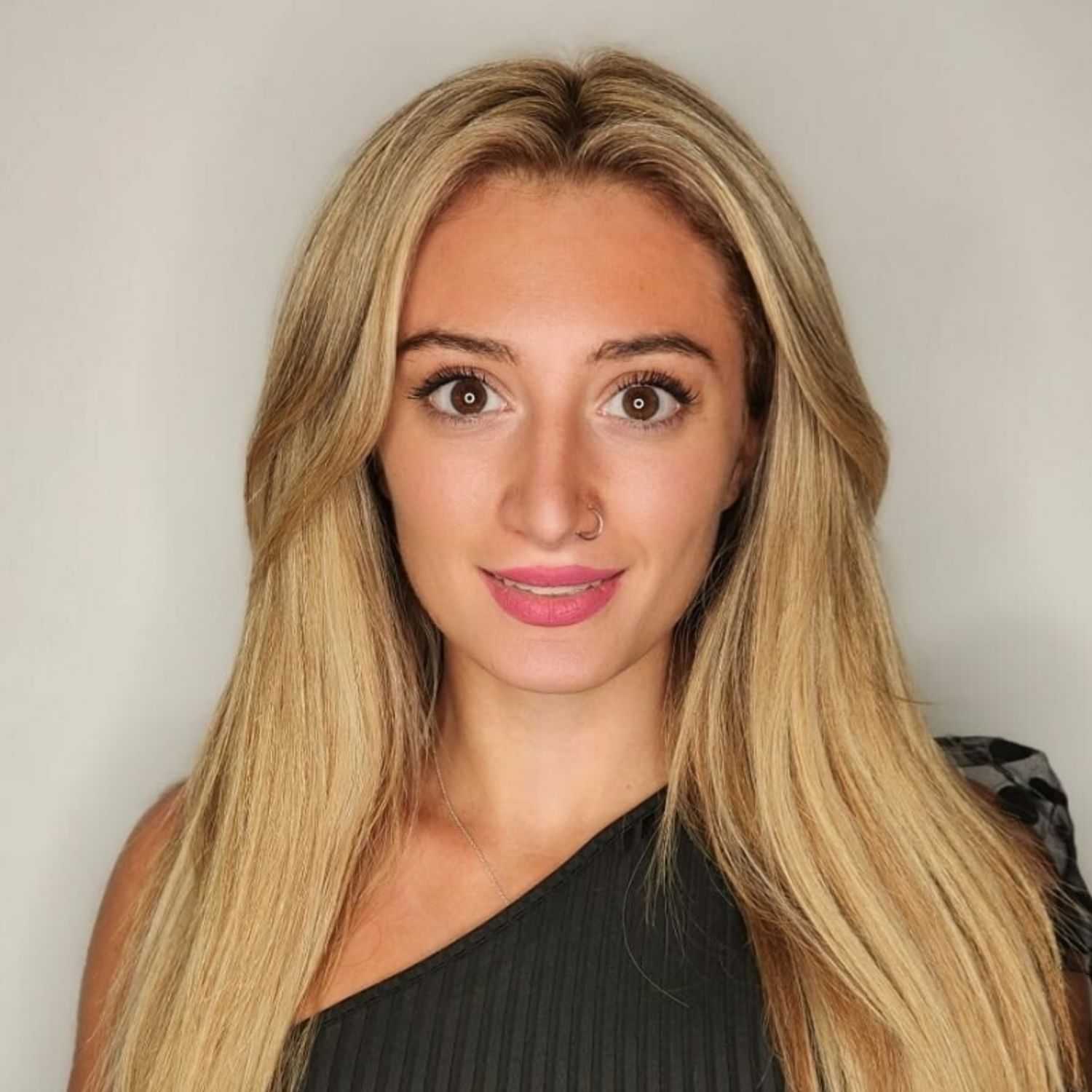 Portrait of Mimi, a professional stylist at The Greenroom Salon, showcasing their expertise and style.