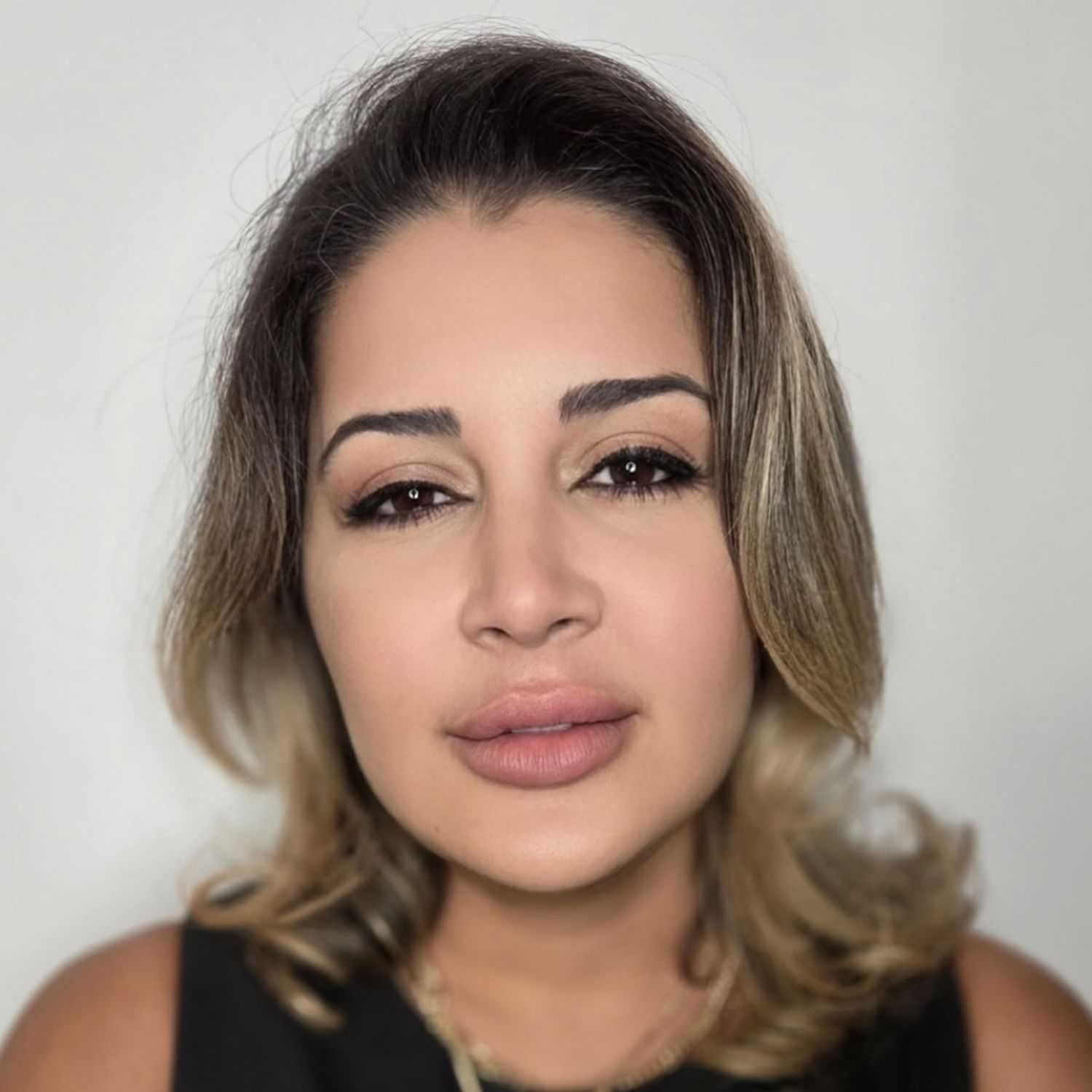 Portrait of Vilma, a professional stylist at The Greenroom Salon, showcasing their expertise and style.