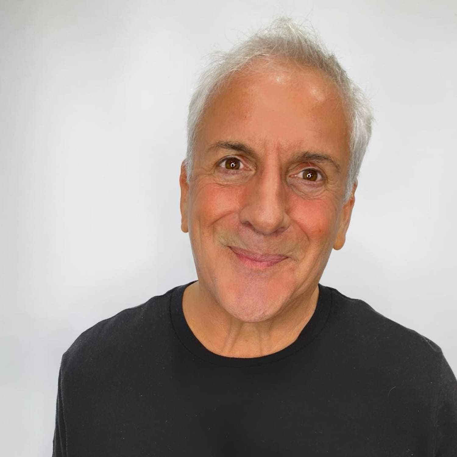 Portrait of Ernie Avallone, a professional stylist at The Greenroom Salon, showcasing their expertise and style.