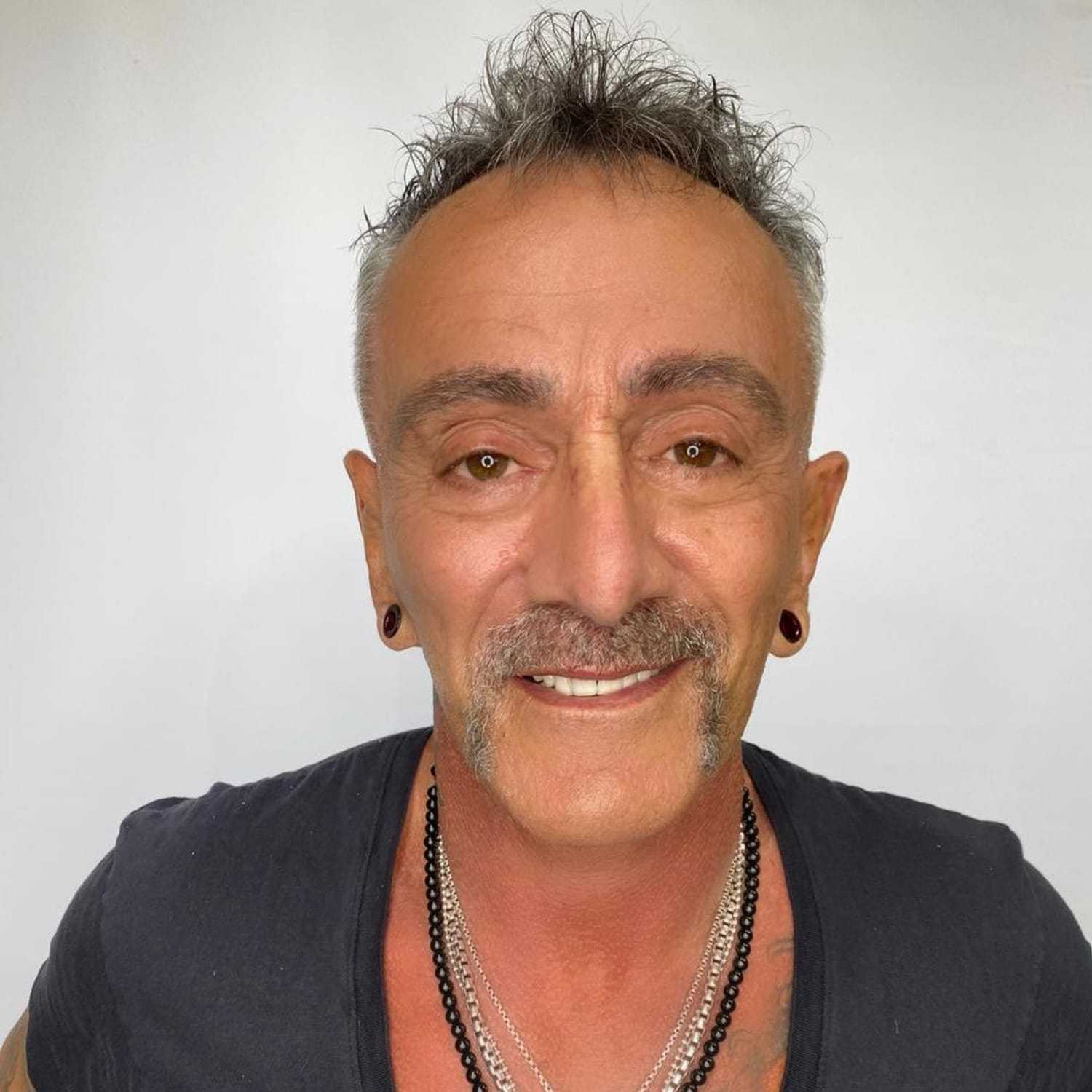 Portrait of Sergio Tridenti, a professional stylist at The Greenroom Salon, showcasing their expertise and style.