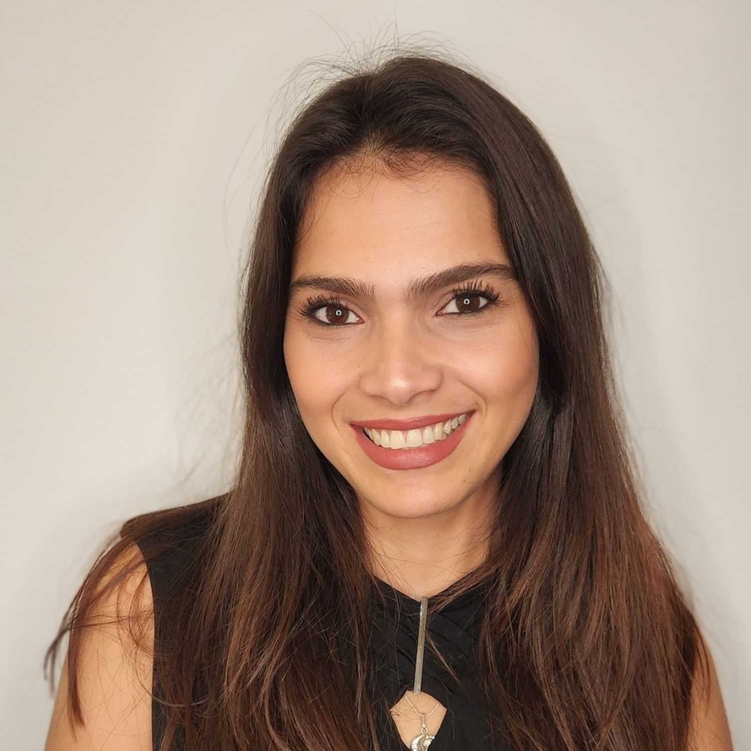 Portrait of Shirley, a professional stylist at The Greenroom Salon, showcasing their expertise and style.