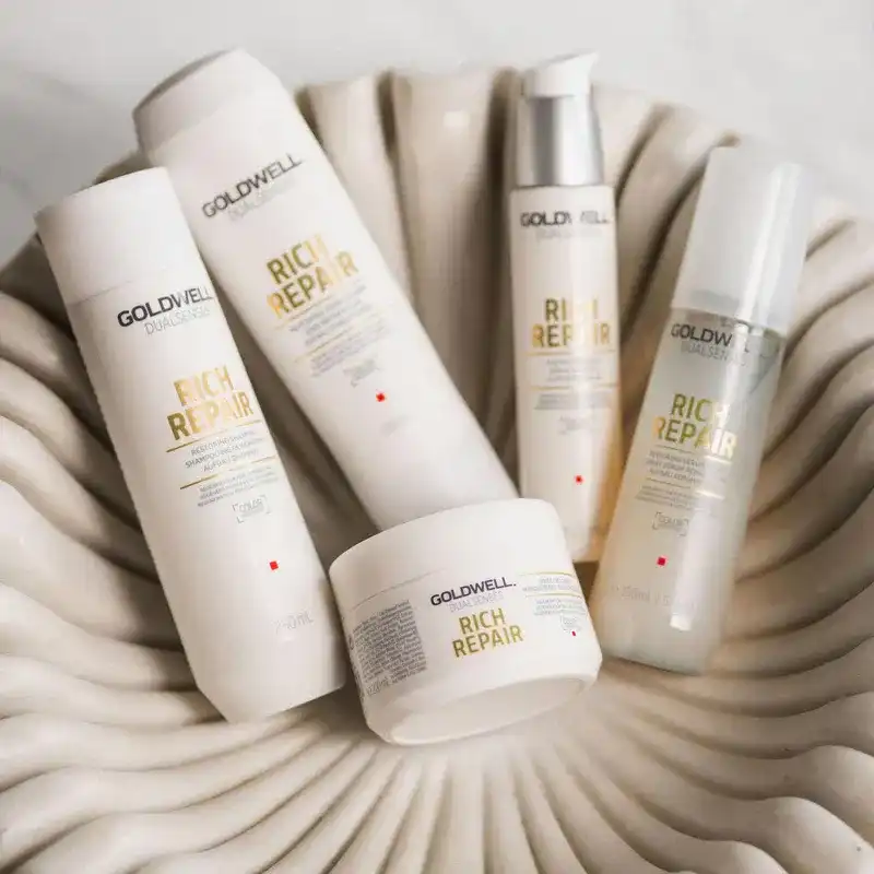 Goldwell Rich Repair hair products displayed in a shell-like dish.