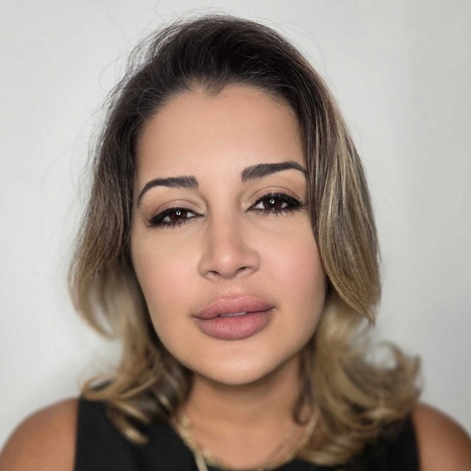 Portrait of Vilma, a professional stylist at The Greenroom Salon, showcasing their expertise and style.