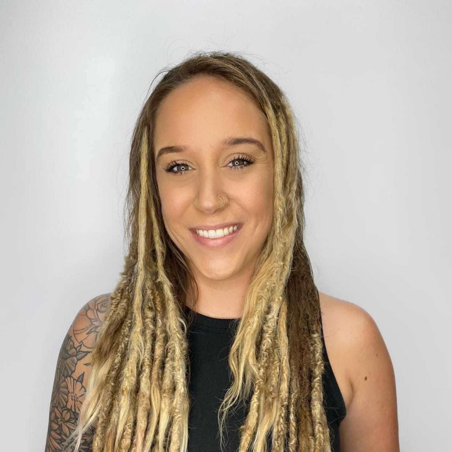 Portrait of Lindsay Newsome, a professional stylist at The Greenroom Salon, showcasing their expertise and style.