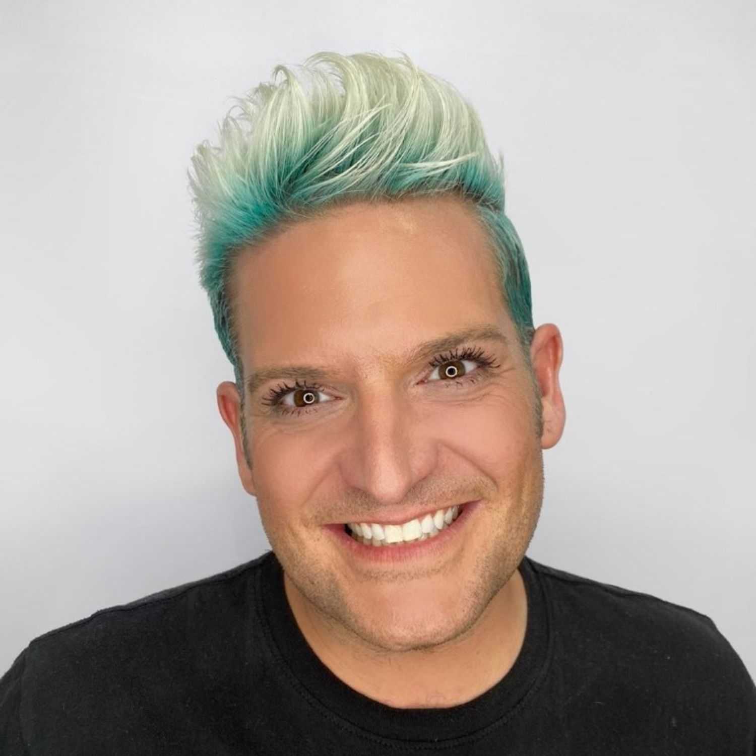 Portrait of Brett, a professional stylist at The Greenroom Salon, showcasing their expertise and style.