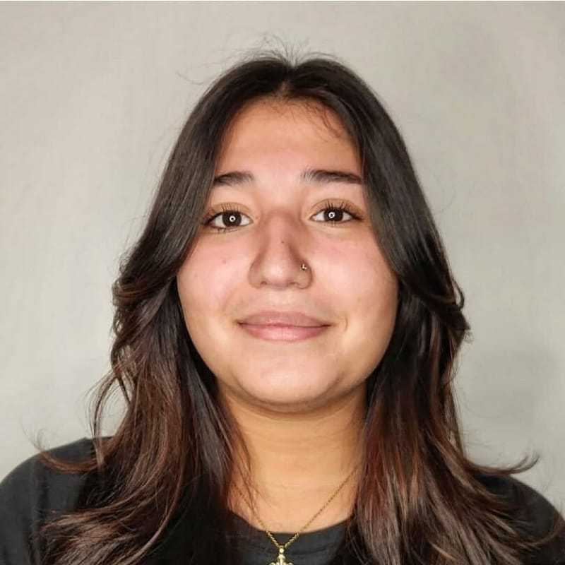 Portrait of Keila, a professional stylist at The Greenroom Salon, showcasing their expertise and style.