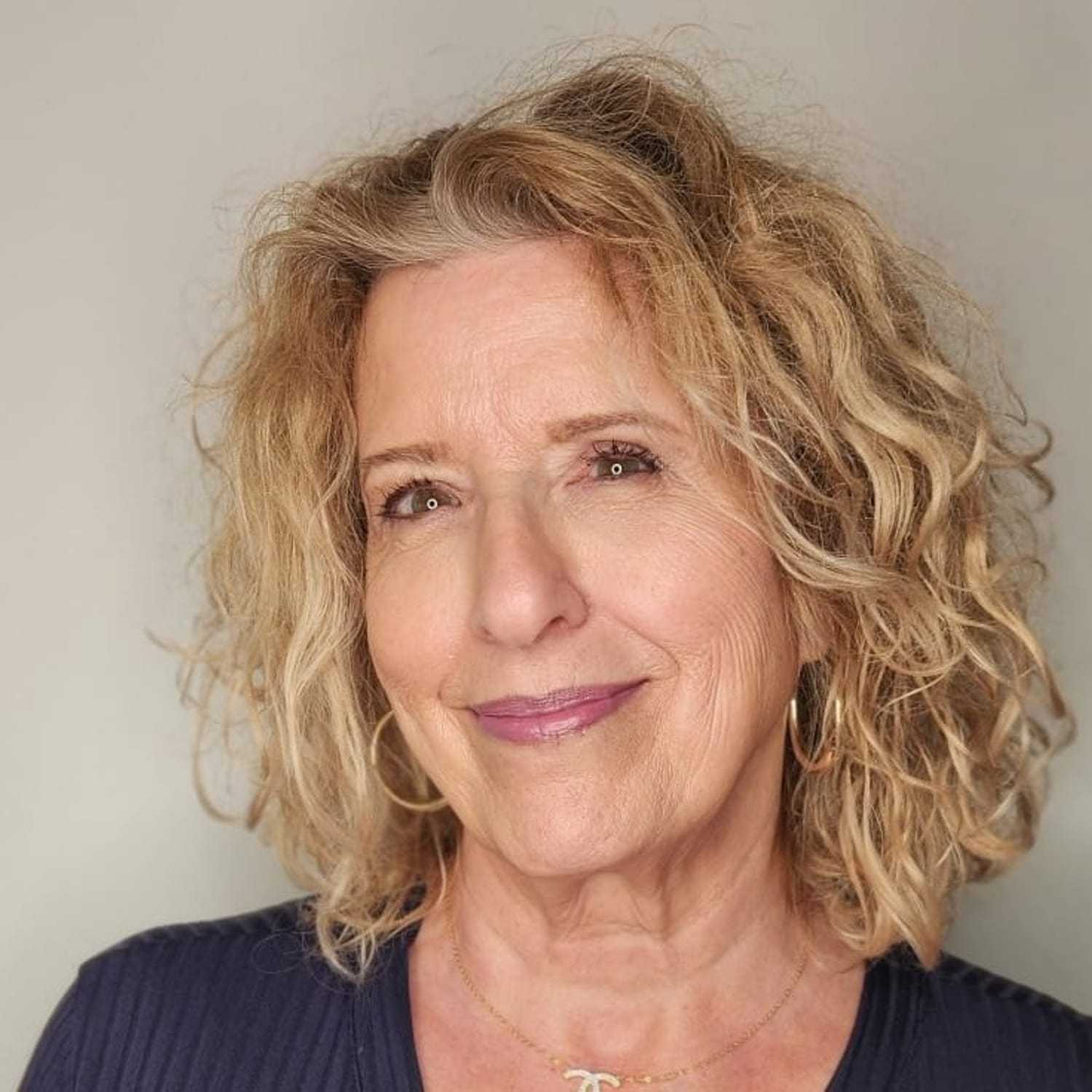 Portrait of Amanda, a professional stylist at The Greenroom Salon, showcasing their expertise and style.