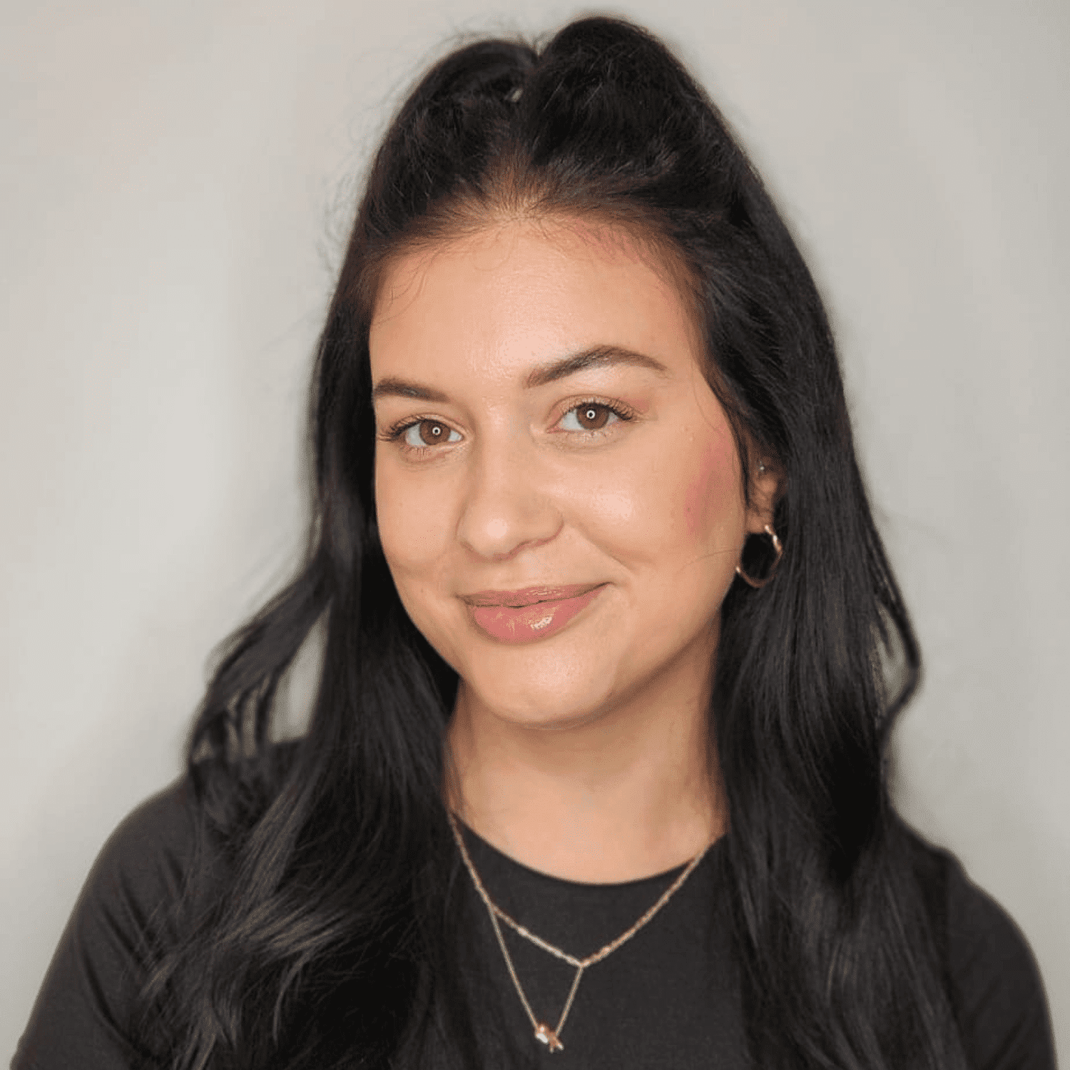 Portrait of Angela, a professional stylist at The Greenroom Salon, showcasing their expertise and style.