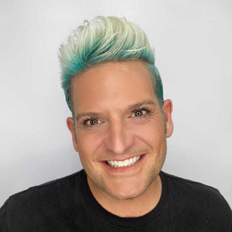 Portrait of Brett, a professional stylist at The Greenroom Salon, showcasing their expertise and style.
